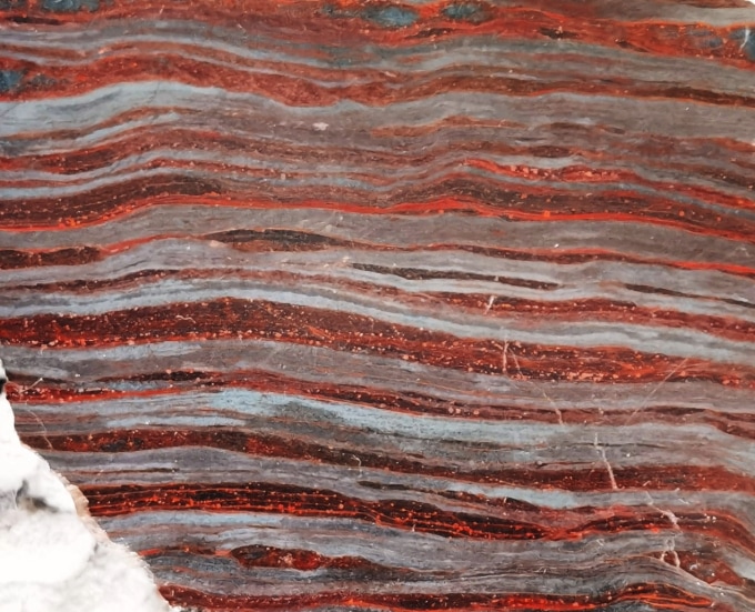 Red and gray bands in a 3.5 billion -year -old rock formation.